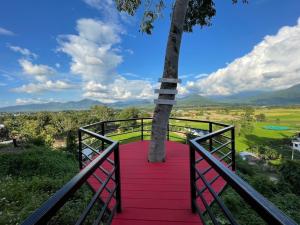 a red carpeted walkway with a tree on it at Pua Panorama Resort in Nan