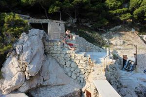 a group of people sitting on a stone stairs at Apartments with a parking space Marusici, Omis - 1041 in Mimice