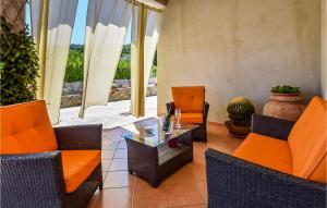 a patio with orange chairs and a glass table at Stunning Home In S M Di Castellabate in Santa Maria di Castellabate