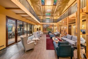 a lobby with couches and chairs and tables at Hotel Eagles Nest in Dharamshala