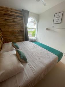 a large bed in a room with a window at NUEVO Depto vista al mar. in Boca del Río