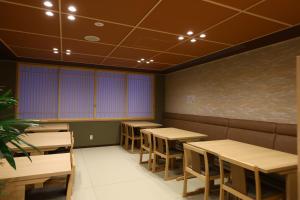 a dining room with tables and chairs and a chalkboard at Onyado Nono Sendai Natural Hot Spring in Sendai