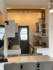 a kitchen with a black refrigerator and a table and chairs at NUEVO Depto vista al mar. in Boca del Río