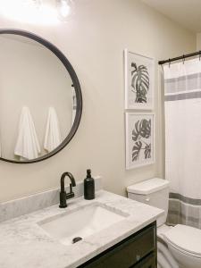 a bathroom with a sink and a mirror at The Ruby - Modern Updated 4/2 Home Near ACU in Abilene