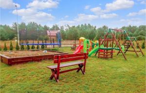 a park with a playground with benches and a slide at Amazing Home In Bialogra With Wifi And 2 Bedrooms in Białogóra