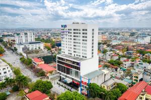 an overhead view of a city with a tall building at SOJO Hotel Thai Binh in Thái Bình