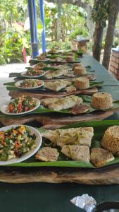 a row of plates of food on a table at Hostal Campomar in Santa Verónica