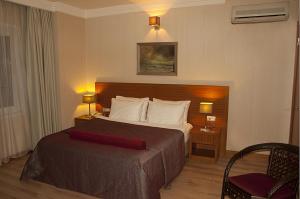 A bed or beds in a room at Island Hotel