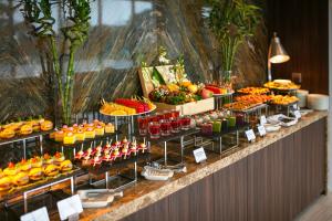 a buffet with many different types of fruits and juices at Mövenpick Living West Hanoi in Hanoi +143 photos