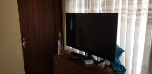 a flat screen tv sitting on top of a dresser at Depto comodo centrico cerca a colegios;hospitales in Cochabamba
