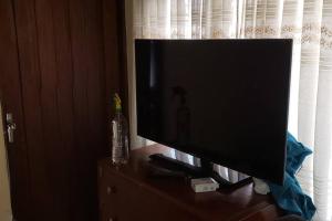 a flat screen tv sitting on top of a dresser at Depto comodo centrico cerca a colegios;hospitales in Cochabamba