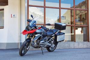 a motorcycle parked in front of a building at Hotel Garni Maria Theresia - Official Ötztal Summer Card Partner in Sölden