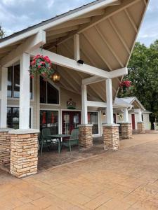 a building with a patio with a table and chairs at Penthouse suite at Holiday Hills Book today in Branson