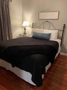 a bed with a black blanket and pillows on it at Penthouse suite at Holiday Hills Book today in Branson