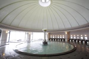 a pool of water in a large room with a ceiling at Noboribetsu Grand Hotel in Noboribetsu +148 photos