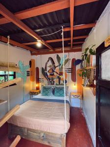 a bedroom with a swing bed in a room at 13 Cielos Hostel in San Cristóbal de Las Casas