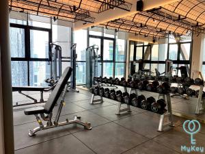 a gym with a bunch of treadmills and machines at Scarletz Suites KLCC by Mykey Global in Kuala Lumpur