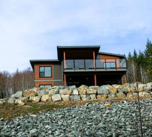 a house on top of a pile of rocks at North Shore Estates Getaway in Lake Cowichan