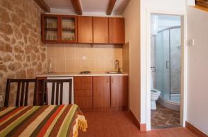 a small kitchen with a sink and a toilet at Apartment Kalajžić Žeževica in Žeževica