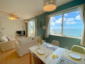 a living room with a view of the ocean at グランディオーソ沖縄ヴィラ金武1 in Okinawa City