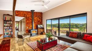 a living room with a couch and a fireplace at Tea Tree Hollow in Canyon Leigh