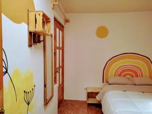 a bedroom with a bed and a rainbow painted on the wall at Casa Tribu in Huaraz