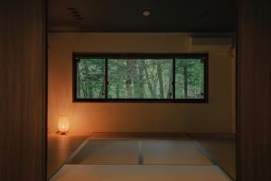 Habitación con ventana y luz en el suelo en Fandina藤原 en Azumaiokozan