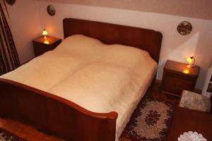 a bedroom with a large bed with two night stands at Haus Prilblume in Detern
