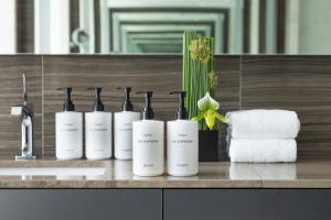 a row of white bottles on a counter in a bathroom at ANA InterContinental Tokyo by IHG in Tokyo