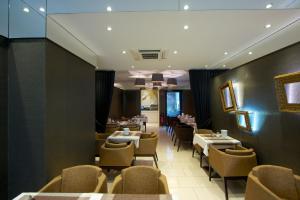 a dining room with tables and chairs in a restaurant at Europa Style in Frankfurt