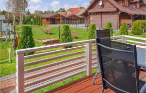 a white fence on a deck with a yard at Nice Home In Sianozety With Wifi in Sianozety