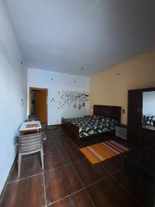 a bedroom with a bed and a tv in it at Odyssey Stays Rathuadhab (Jim Corbett National Park) in Badīyārgaon