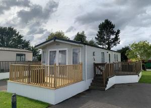 a small house with a porch and a deck at Cawood Country Park in Cawood