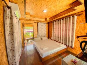 a small bedroom with a bed in a room at Baan Rung Tawan in Ban Bang Nao +16 photos