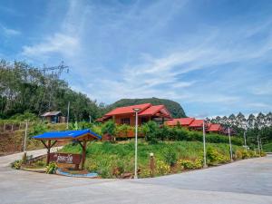 a group of houses on a hill next to a road at Baan Rung Tawan in Ban Bang Nao
