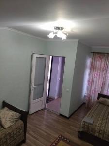 a living room with a bed and a ceiling fan at Hotel Gostinyi Dvor in Bosteri