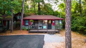 a cabin in the woods with a lot of trees at Log Cabin Motor Court in Asheville