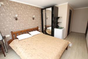 a bedroom with a bed and a mirror at Santa-Fe Hotel in Koktebel