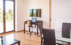 an office with a desk with a laptop and chairs at Nice Apartment In Grzybowo With Kitchenette in Grzybowo