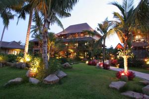 a resort with palm trees and lights in the yard at Bo Phut Resort and Spa - SHA Plus in Bophut