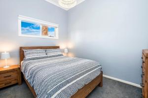 a bedroom with a bed and a window at Salty's - Newly Renovated in Port Fairy