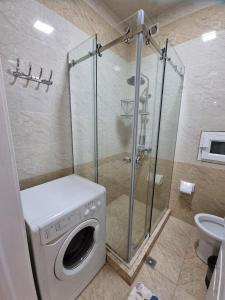 a bathroom with a washing machine and a shower at Квартира в аренду Tashkent in Tashkent