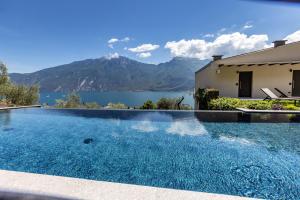 a swimming pool with a view of a lake at LLAC Living Nature Hotel in Limone sul Garda