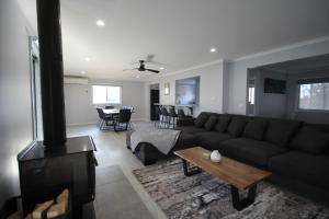 a living room with a couch and a fireplace at Phillip Island Park Lane Holiday Park in Cowes