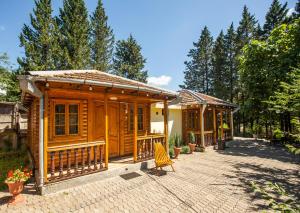 a couple of wooden cottages on a brick patio at Eco Cottage in Kutaisi