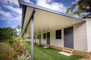 an exterior view of a building with green grass at Solitary Islands Resort in Wooli