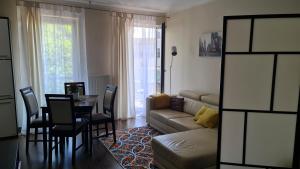 a living room with a couch and a table and chairs at Apartament Villa Concha in Świnoujście