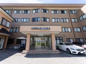 a hotel garage with a white car parked in front of it at Tabist Daibou Ichihara Mens Only in Ichihara