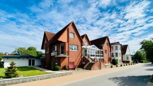 a house with a staircase in front of it at Pension Kühne in Boltenhagen