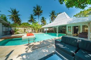 a villa with a swimming pool and a house at Villa Merano - Huge pool - Meno in Gili Meno